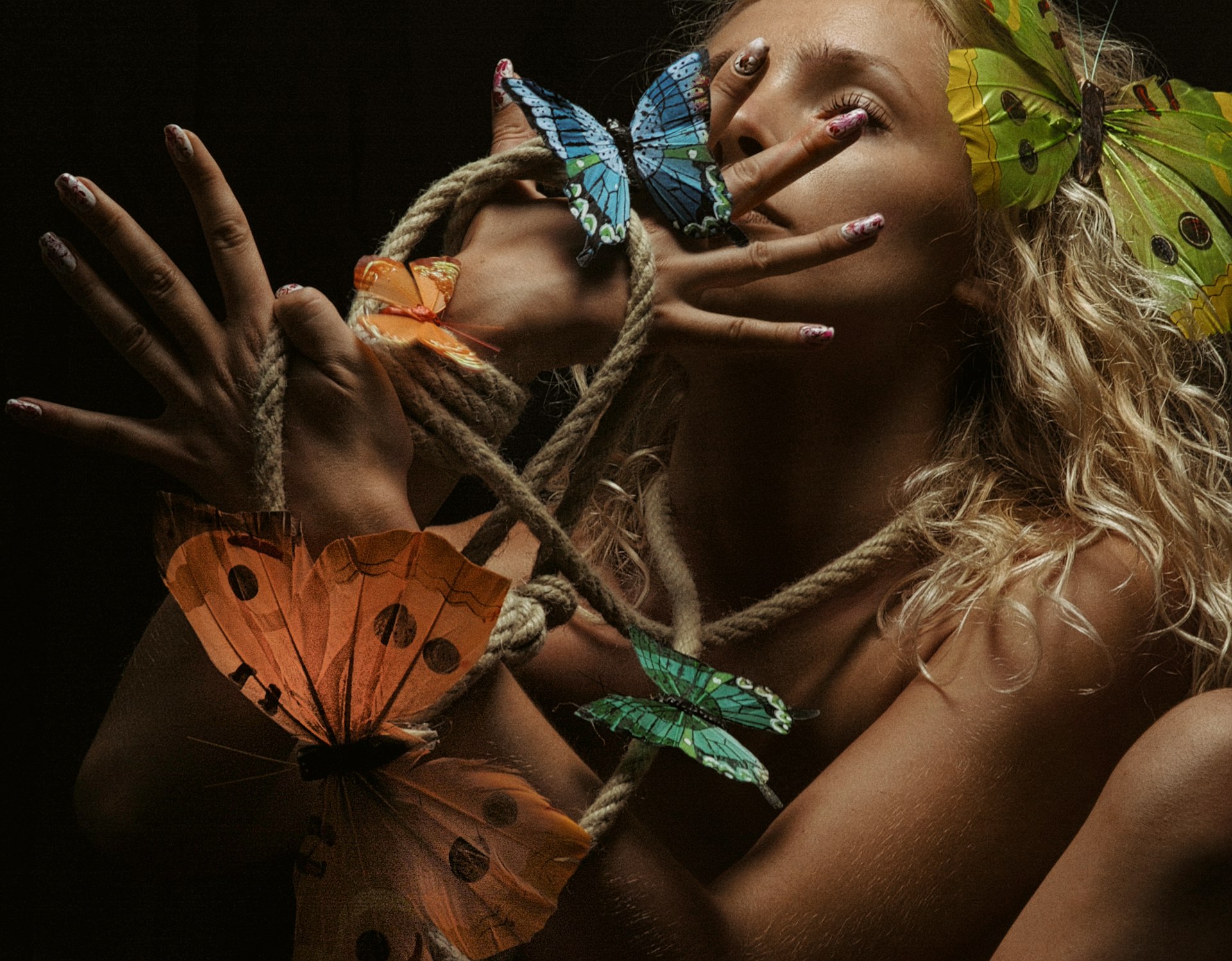 a woman with butterflies on her face and hands